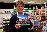 15-12-2022 Breda - Burgemeester Paul Depla heeft bij boekhandel van Kemenade & Hollaers het 3e deel van het beelddocument Breda in coronatijd in ontvangst genomen. Het 3e fotoboek gaat over 2022 met oa de laatste lockdown, de massale vaccinatie en het open gaan van de maatschappij met feest. - Fotokrant