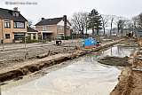 28-01-2022 Ulvenhout - In het kerkdorp is de straat veranderd in een rivier. Men is bezig met het aanleggen van riolering en regenwaterafvoeren. - Fotokrant